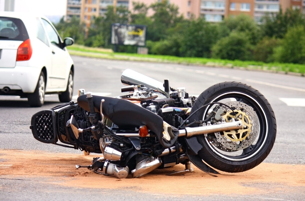 Motorcycle on its lying on its side after an accident indicating the need for an Idaho motorcycle accident lawyer.